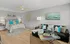 Chic bedroom with stylish decor, featuring a comfortable bed, vibrant cushions, and a cozy seating area.
