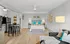 Contemporary studio apartment with open layout featuring a cozy bed, stylish kitchen, and elegant decor.