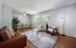 Inviting living room with modern furniture, large windows, and warm lighting.