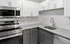 Sleek modern kitchen with granite countertops, stainless steel appliances, and stylish cabinetry.