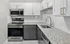 Modern kitchen with granite countertops, stainless steel appliances, and sleek cabinetry.