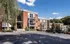 Somerset Apartments in Mount Lookout Exterior, three-story red brick apartment building with balconies and lush greenery.