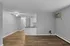 Modern open-concept living room with elegant hardwood flooring and a cozy kitchen area.