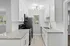 Contemporary kitchen with sleek white cabinetry, granite countertops, and stainless steel appliances.