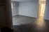 Elegant apartment with sleek flooring, natural light, and modern amenities, offering a warm and inviting atmosphere.