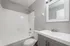 Contemporary bathroom featuring a sleek bathtub, modern vanity, and stylish mirror.