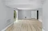 Bright, spacious living area with wood flooring and large sliding glass doors leading to a private patio.
