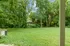 Serene apartment view with lush greenery and a spacious backyard.