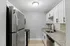 Sleek and modern kitchen with stainless steel appliances, granite countertops, and white cabinetry.