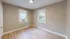 Inviting bedroom with large windows, natural light, and elegant wood flooring.