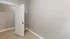 Bright entryway with an open white door and sleek hardwood flooring.
