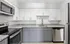 Sophisticated kitchen design featuring stainless steel appliances, granite countertops, and stylish cabinetry.