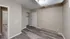 Inviting bedroom with elegant wooden flooring and ample closet space, featuring a modern light fixture.