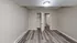 Modern empty bedroom with sleek flooring and built-in closet.