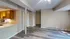 Bright, open-concept living area with modern hardwood flooring adjacent to a cozy kitchen with wooden cabinets.