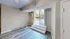Inviting apartment space with light wood flooring and a patio entrance featuring steps and natural light.