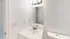 Bright and modern bathroom featuring a sleek vanity with a mirror and contemporary lighting.