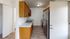 Inviting galley kitchen with wooden cabinets, modern stainless steel appliances, and elegant flooring.