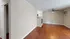 Bright open-plan living room with hardwood floors and modern kitchen.