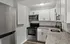 Sleek modern kitchen featuring stainless steel appliances, granite countertops, and white cabinetry.
