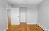 Bright and airy room featuring elegant hardwood flooring and a spacious closet, perfect for a cozy retreat.