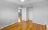 Bright and inviting bedroom with gleaming hardwood floors, spacious closet, and modern ceiling fan, offering a serene living space.