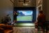 Modern indoor golf simulator room featuring a cutting-edge virtual golf screen, with a player practicing their swing and an inviting lounge atmosphere at the Ave Apartments in Columbus, OH.