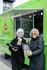 Vibrant food truck scene with two happy women enjoying fresh, flavorful meals from a green jalapeño-themed truck at The Ave apartments in Columbus, OH