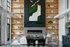 Elegant living space with high ceilings, modern fireplace, and stylish shelving. Contemporary art piece adds a chic touch at The Ave apartments in Columbus, OH. Apartments with coffee bar columbus ohio.