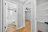 Modern apartment hallway with sleek hardwood floors, leading to a bright bathroom and airy bedroom, complemented by built-in shelving. Oakley Square Apartments Cincinnati, 2-Bedroom Apartments in Oakley Cincinnati, Pet-Friendly Apartments in Oakley, Renovated Apartments near Hyde Park, Sunset Cincy Oakley Square Apartments, Apartments in Oakley Cincinnati, Apartments near Rookwood Commons, Apartments near Hyde Park Cincinnati.