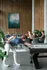 Rooftop lounge at The Ave Apartments in Columbus, OH. Pool table and people sitting at a large table having a conversation in the background. Apartments with amenities in Columbus, OH.