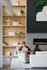 Contemporary living room featuring elegant wooden shelving, modern decor, and a cozy fireplace, creating a welcoming atmosphere.
