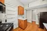 Charming kitchen with sleek wooden cabinetry, modern appliances, and elegant hardwood flooring.