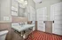 Charming bathroom with elegant marble sink and vibrant geometric tile flooring, featuring stylish cabinetry and soft lighting.