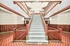 Elegant apartment staircase showcasing rich wooden paneling and classic design.