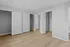 Bright and spacious empty room with light wood flooring, ample closet space, and modern gray walls, offering a blank canvas for personal style and comfort.