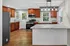 Beautiful modern kitchen with rich wooden cabinets, stainless steel appliances, and an elegant marble countertop island.