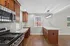 Modern kitchen featuring sleek stainless steel appliances, elegant wood cabinetry, and a stylish marble countertop with accent lighting.