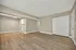 Bright and inviting living area with modern wooden flooring and neutral walls, featuring a ceiling fan and ample space for personalization.