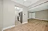 Chic modern apartment with open-concept living area, sleek kitchen, and elegant wood flooring.