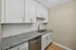 Elegant kitchen featuring sleek granite countertops, white cabinetry, and gold fixtures for a luxurious touch.