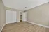 Inviting bedroom with elegant wooden flooring, neutral walls, and a spacious closet.