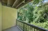 Charming balcony with a lush green view, offering a serene outdoor retreat surrounded by nature.