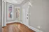 Charming entrance with elegant hardwood floors and vintage-style windows, creating a welcoming ambiance.