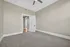 Inviting and spacious bedroom featuring plush carpeting, neutral walls, and elegant white trim for a modern yet cozy feel.