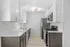 Modern kitchen with sleek cabinetry, stainless steel appliances, elegant gold fixtures, and bright lighting.