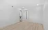 Bright, freshly painted room with sleek wood flooring, recessed lighting, and modern white doors.