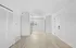 Bright and modern open space featuring light wood flooring, two pendant lights, and large windows with shutters, offering a blank canvas for personalized design.