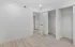 Bright and modern room with dual closets and elegant hardwood flooring, perfect for storage and style.