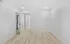 Bright, newly renovated room with modern wood flooring and fresh white walls, offering a sleek and minimalistic design.